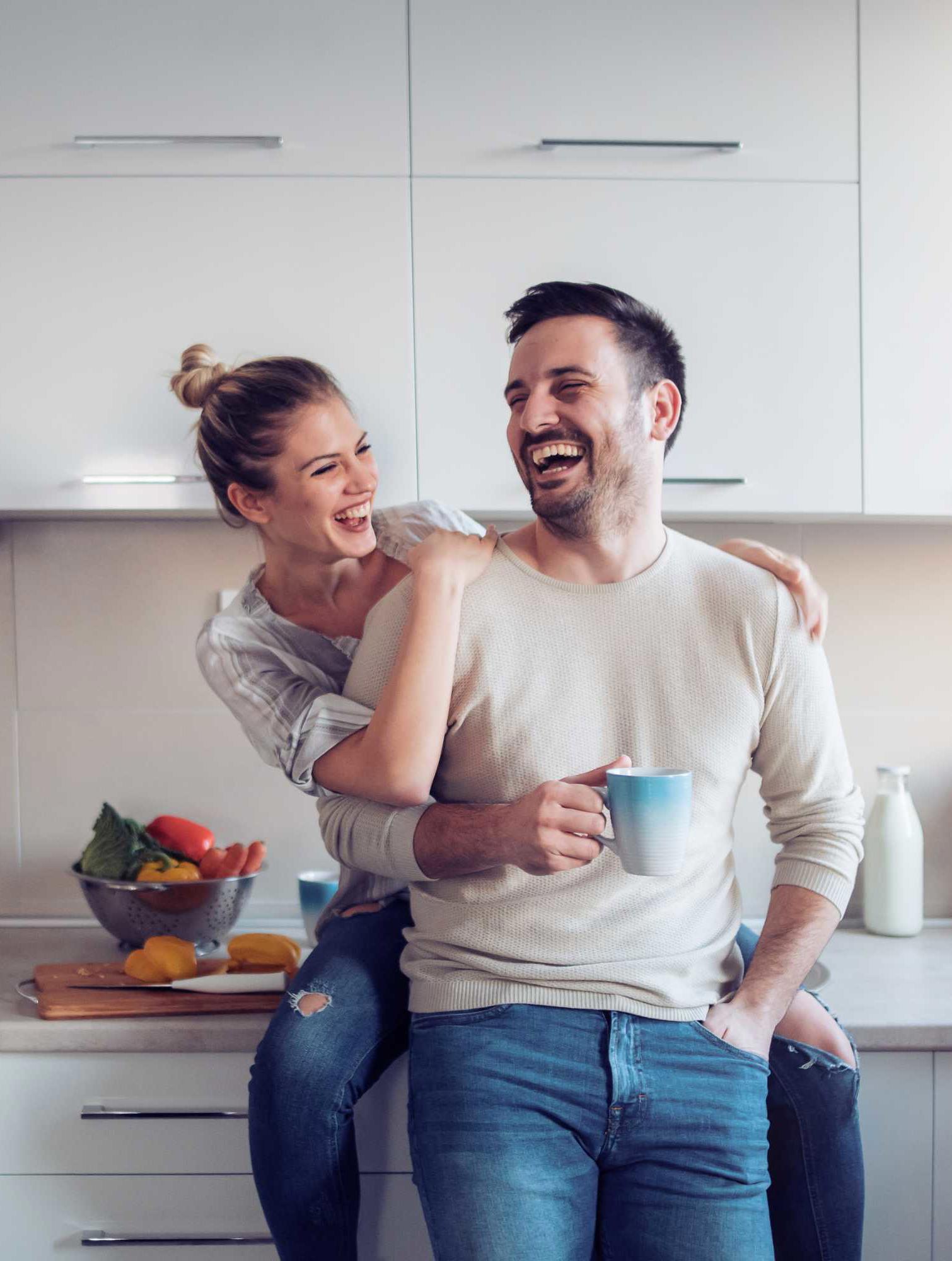 Happy couple in new kitchen and home