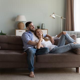 Couple on a sofa in new Gecko home